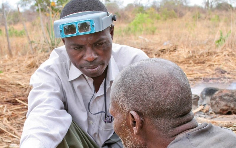 An eye care worker consulting with a patient in the community. TANZANIA. © Lance Bellers/Sight Savers