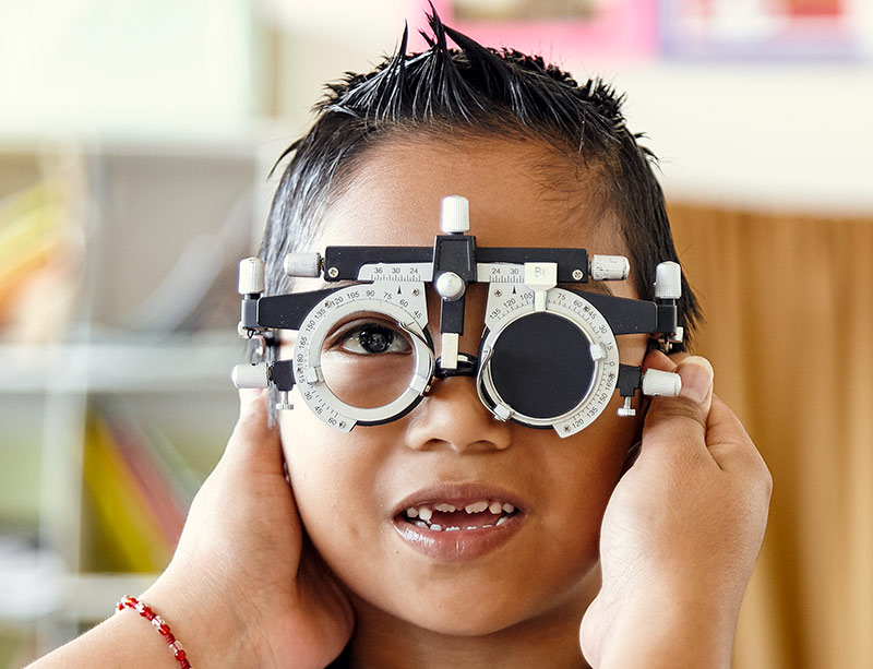 Child wearing refracting spectacles