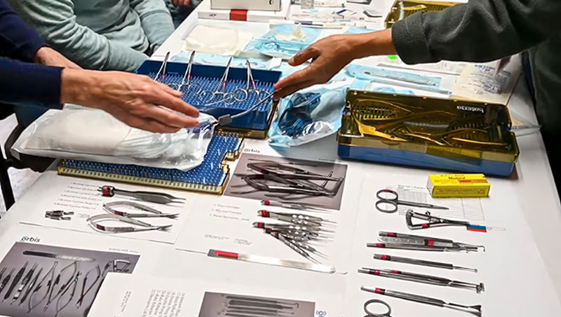 Many surgical instruments laid out on a table.
