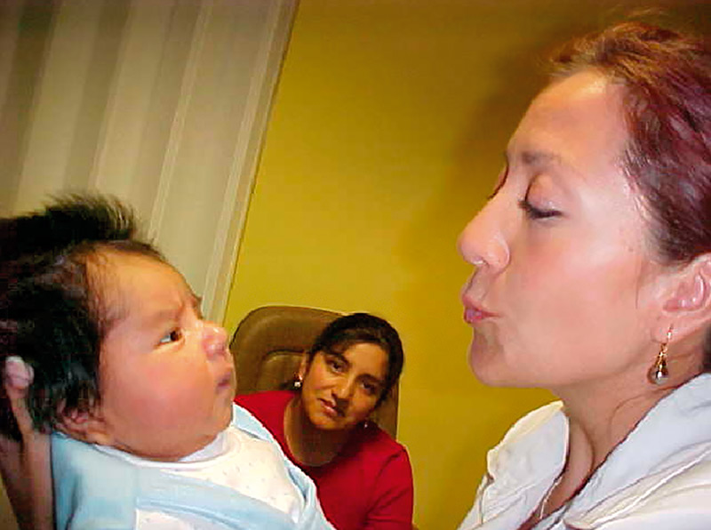 Female ophthalmologist holding a young baby